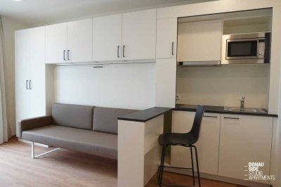 ERSTBEZUG - DONAU SIDE: Modernes Studio Apartment mit Terrasse, Fitnessstudio & Co-Working