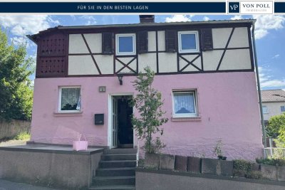 Verkauf: Schnuckeliges Einfamilienhaus mit Weitblick und Sanierungsbedarf in Höhenlage von Höchberg