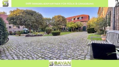 SAYAN Immobilien - Rondorf: Traumhafte Gartenwohnung in historischer Hofanlage + PKW-Stellplatz -