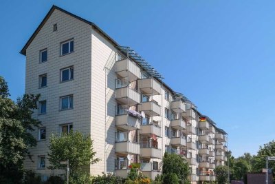 Sonniger Balkon mit Blick auf gepflegte Außenanlagen