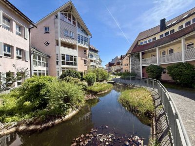 Wohnen im Einklang mit Natur und Architektur – außergewöhnliche Maisonette-Wohnung mit Wintergarten