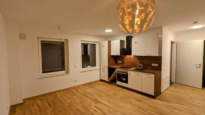 Moderne 2-Zi.-Neubau mit EBK, TG & Waschmaschine – Zentrumsnah, 5 Min. Hbf