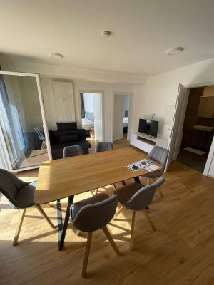 Erstbezug: Stilvolle 3-Zimmer-Neubauwohnung mit 2 Balkonen, Garage, Stellplatz und voll ausgestatteter Küche – sofort bezugsfertig