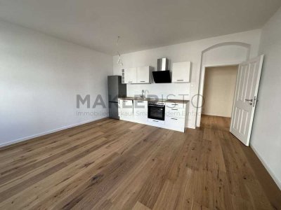 **Modernisierte 3-Zimmer-Erdgeschosswohnung mit Einbauküche, Balkon, Gartenanteil & Stellplatz**