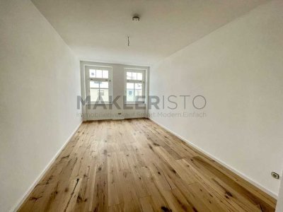 **Modernisierte 2-Zimmer-Erdgeschosswohnung mit Balkon und eigenem Gartenanteil**